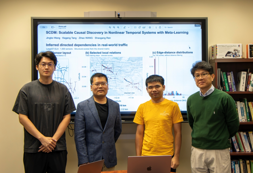 Four UTC computer science researchers stand before a presentation screen showing traffic-data visualizations from their NeurIPS-accepted causal-discovery paper.