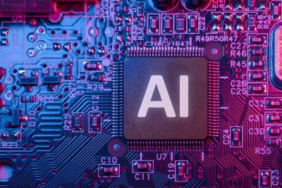 نمای نزدیک تراشه‌ای با عبارت AI روی برد مدار الکترونیکی