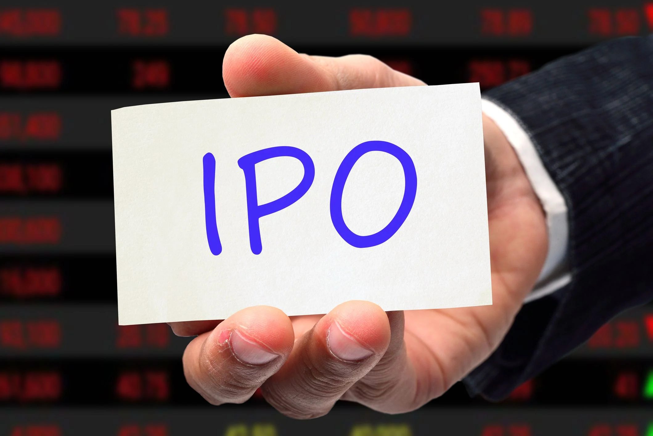 An investor holding a cart that says "IPO" in their hand.