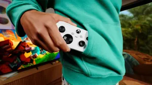 The Xbox Nano controller is shown being slipped into a sweatshirt pocket.