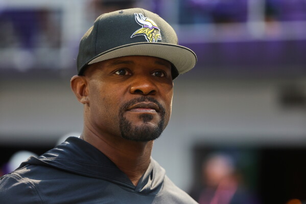 Minnesota Vikings defensive coordinator Brian Flores watches during warm ups before an NFL preseason football game against the Baltimore Ravens, Aug. 22, 2026, in Minneapolis. (AP Photo/Bruce Kluckhohn, File)