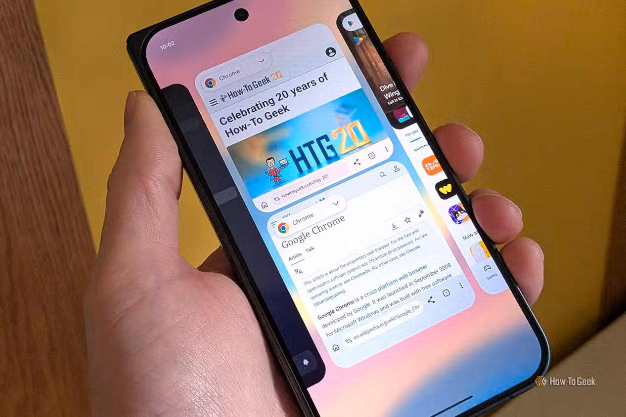 An image of a person holding a phone, with Chrome open, switching between tabs.